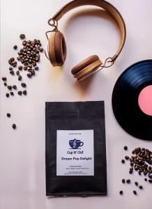 Cup N' Clef Dream Pop Delight coffee bag displayed alongside a vintage headphone and vinyl record, emphasizing the blend of music and rich coffee flavors.