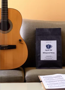 Whispered Notes Coffee Bag on Couch with Guitar